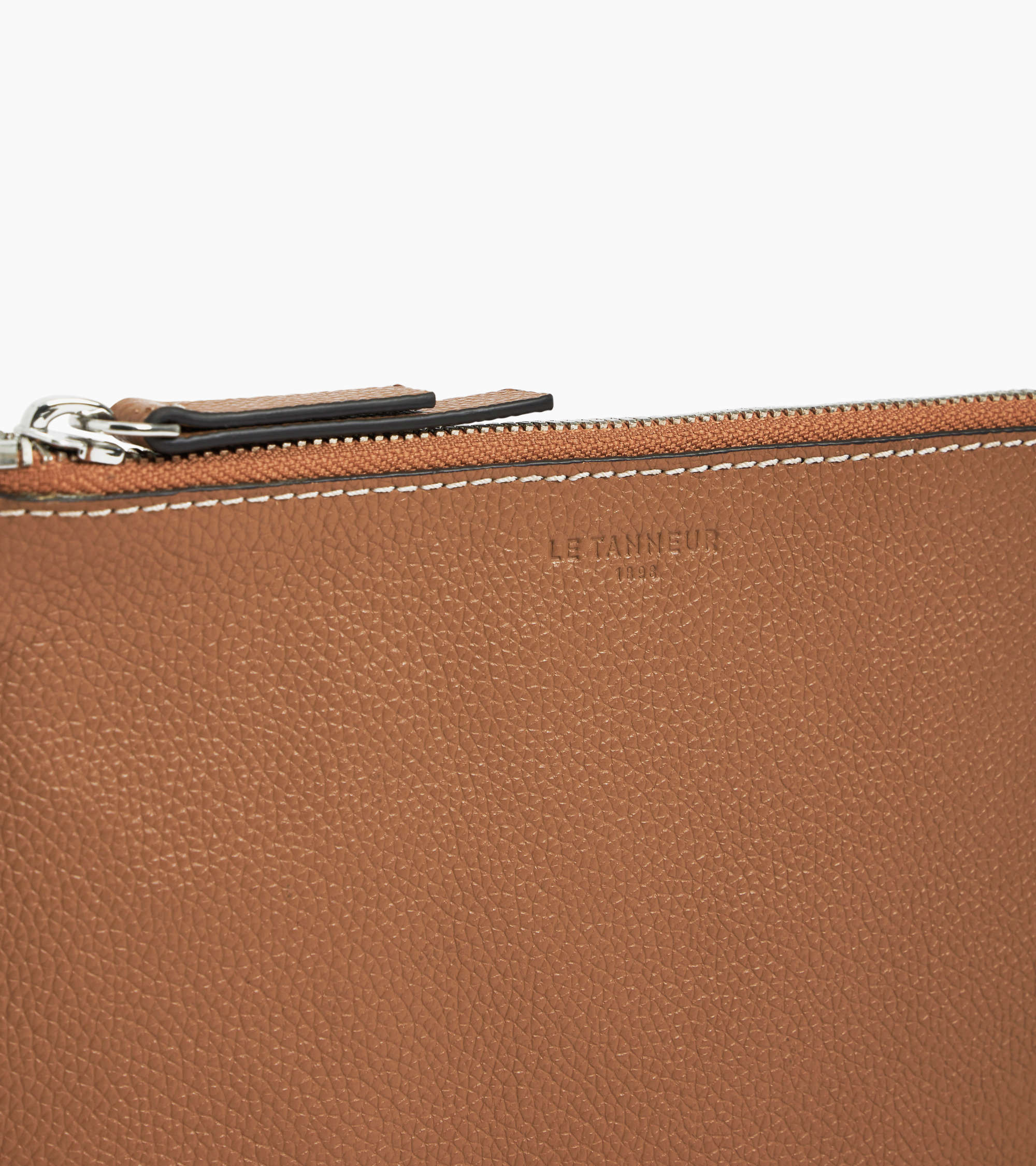 Zipped pouch with a grained leather strap